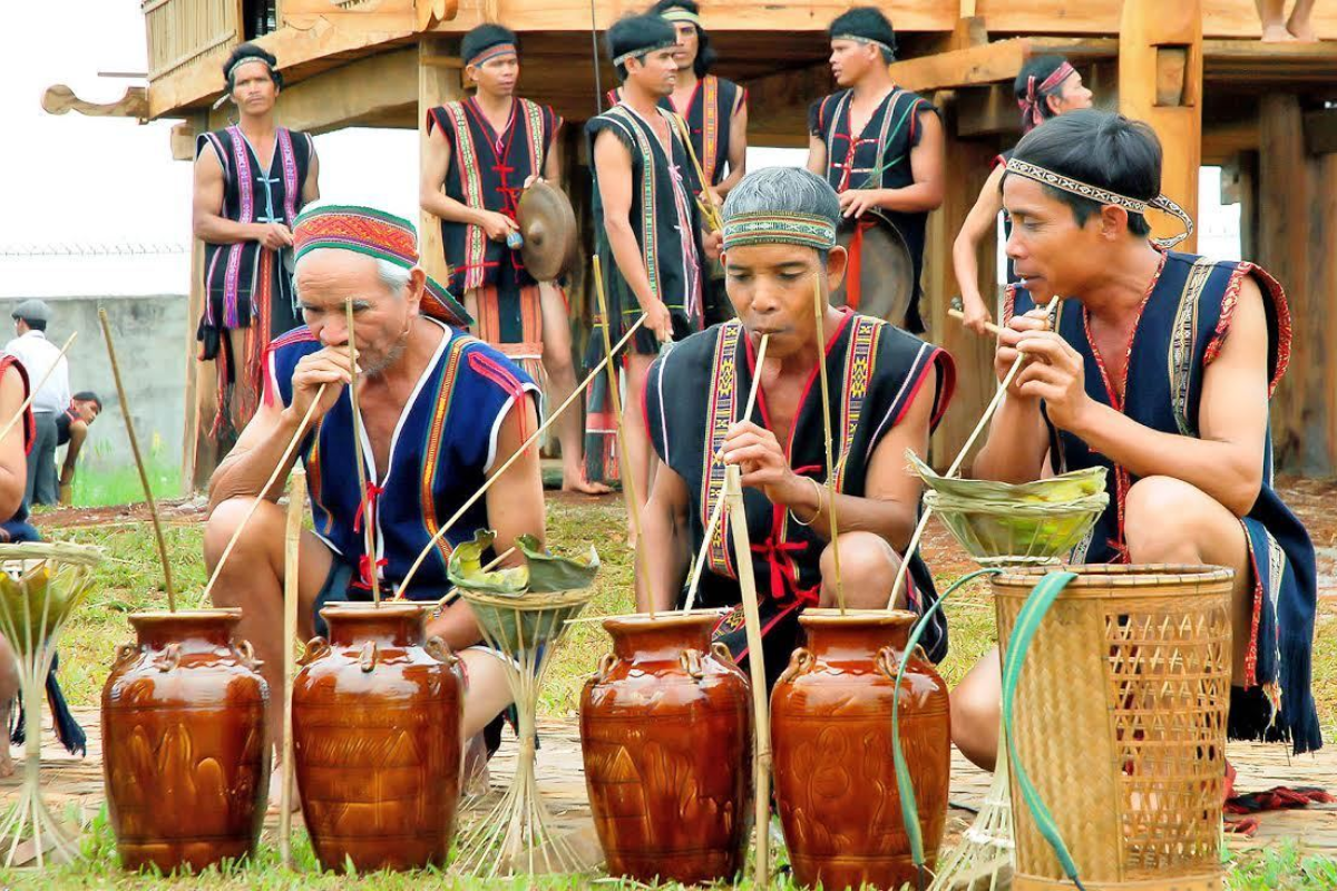 Traditional Muong rice wine in large jars with bamboo straws